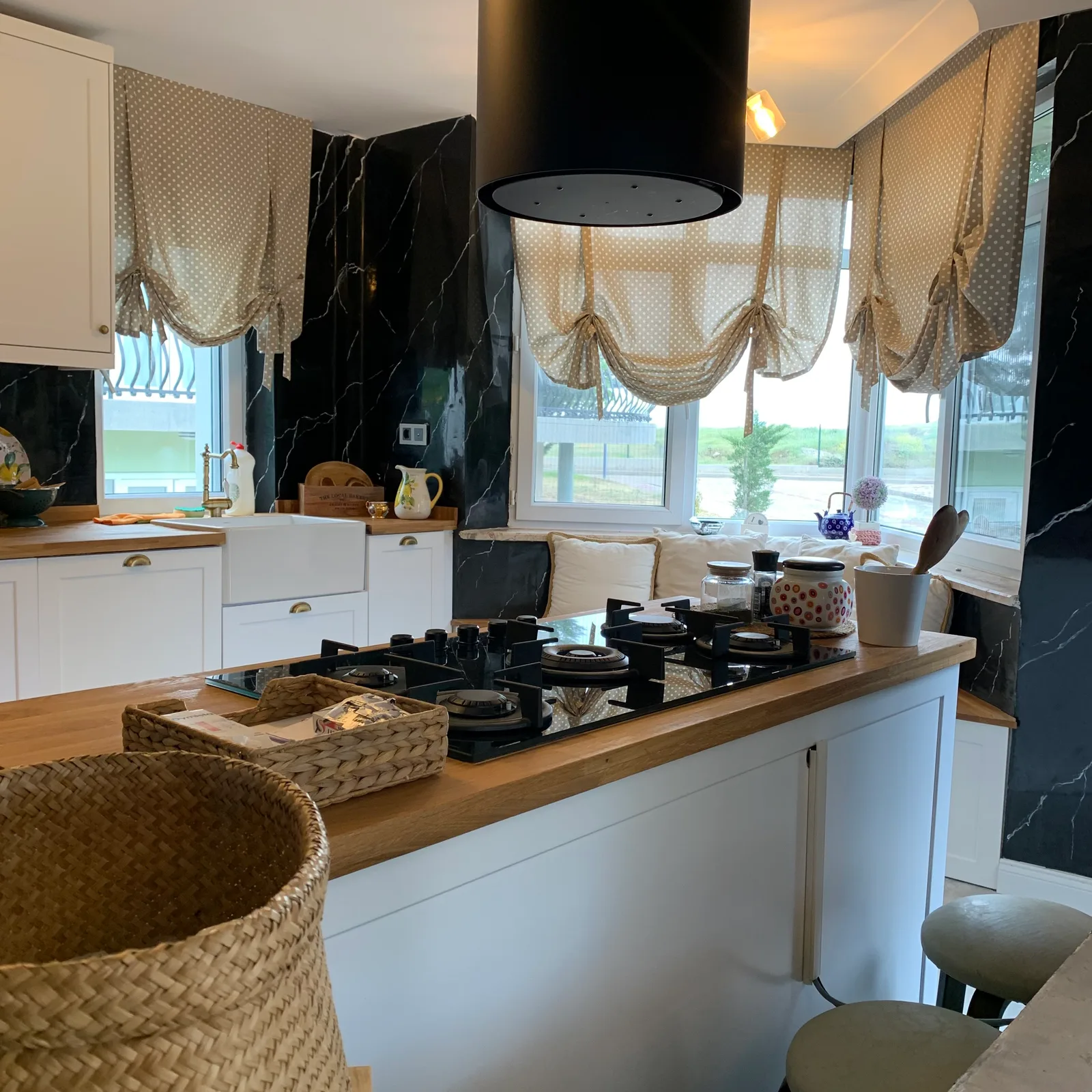 Overview of beige polka-dot balloon curtains in a kitchen