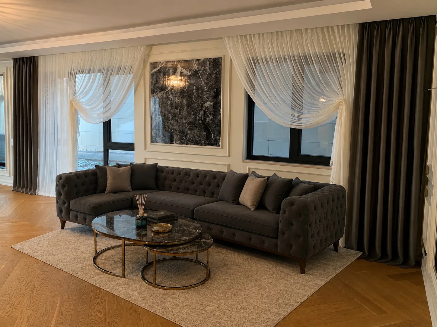 White cross-over sheers and dark neutral drapes in a villa living room at Lima Elit, Çayyolu