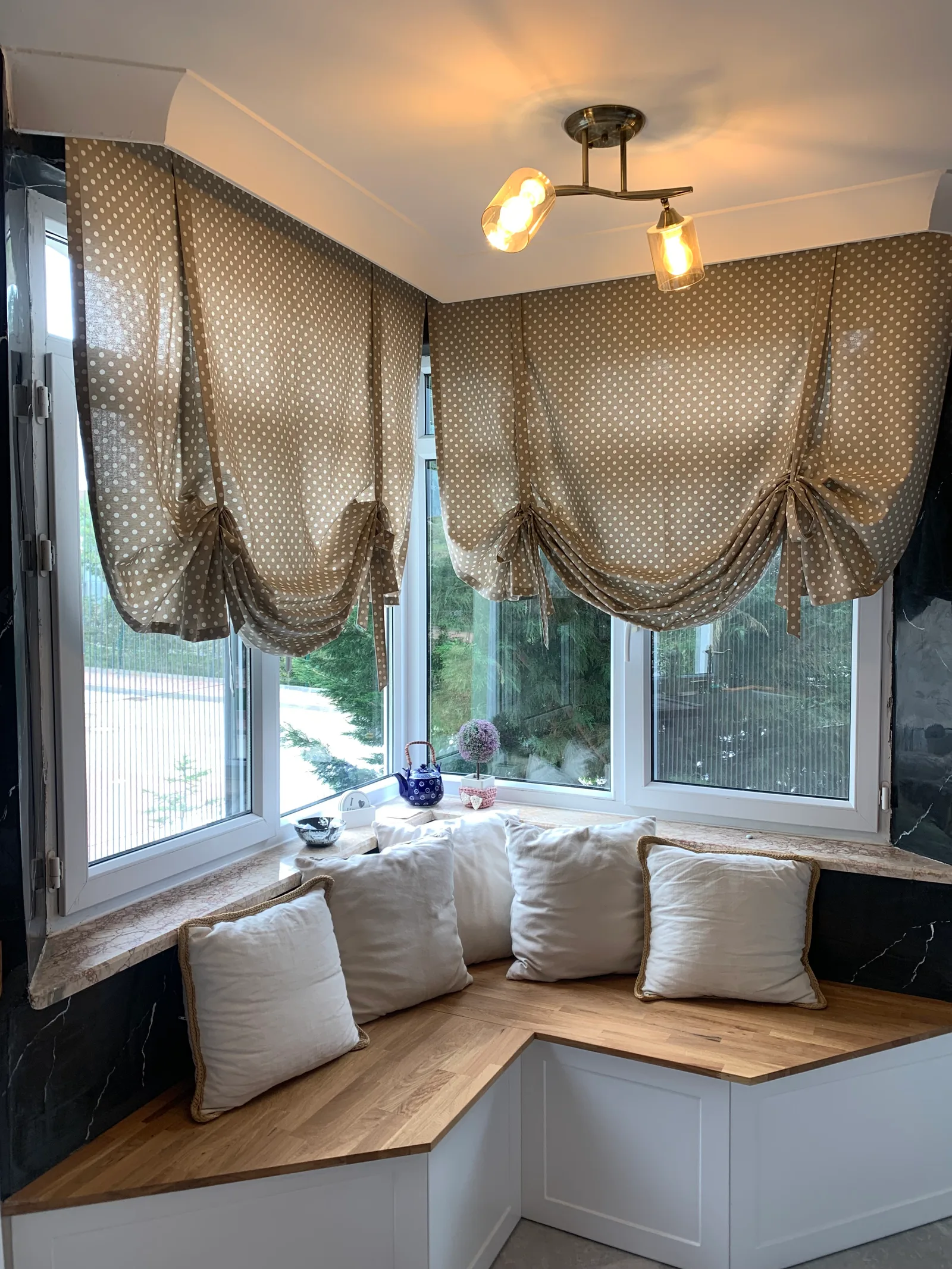 Beige polka-dot balloon curtains on corner kitchen windows