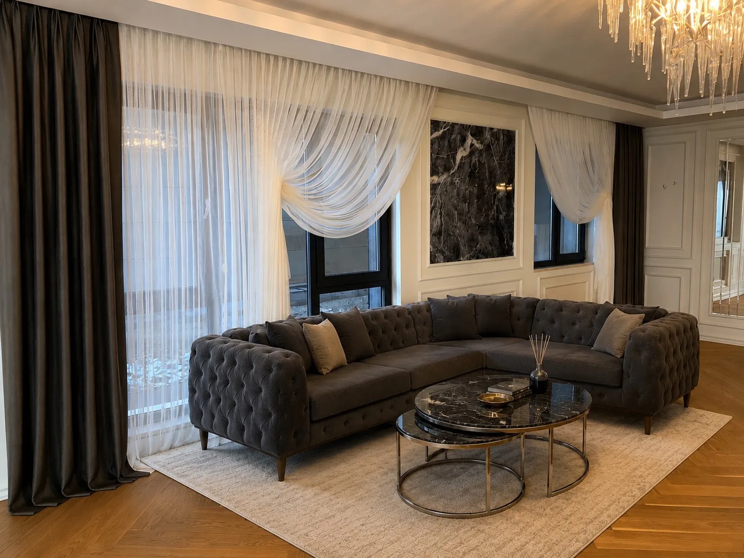 Side view of draped white cross-over sheers and dark curtains in the Lima Elit villa living room