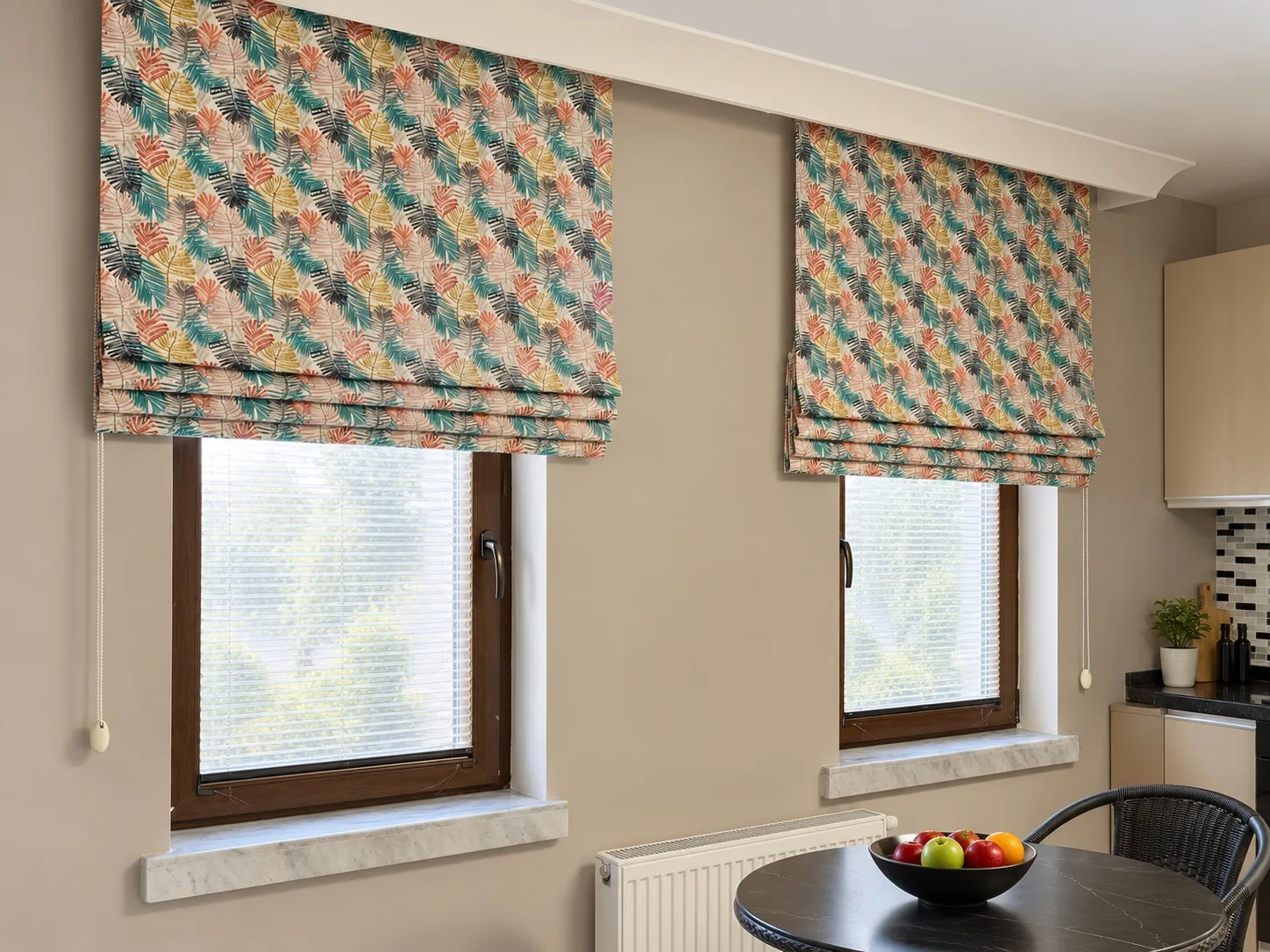 Roman blinds with a colourful leaf pattern on two kitchen windows