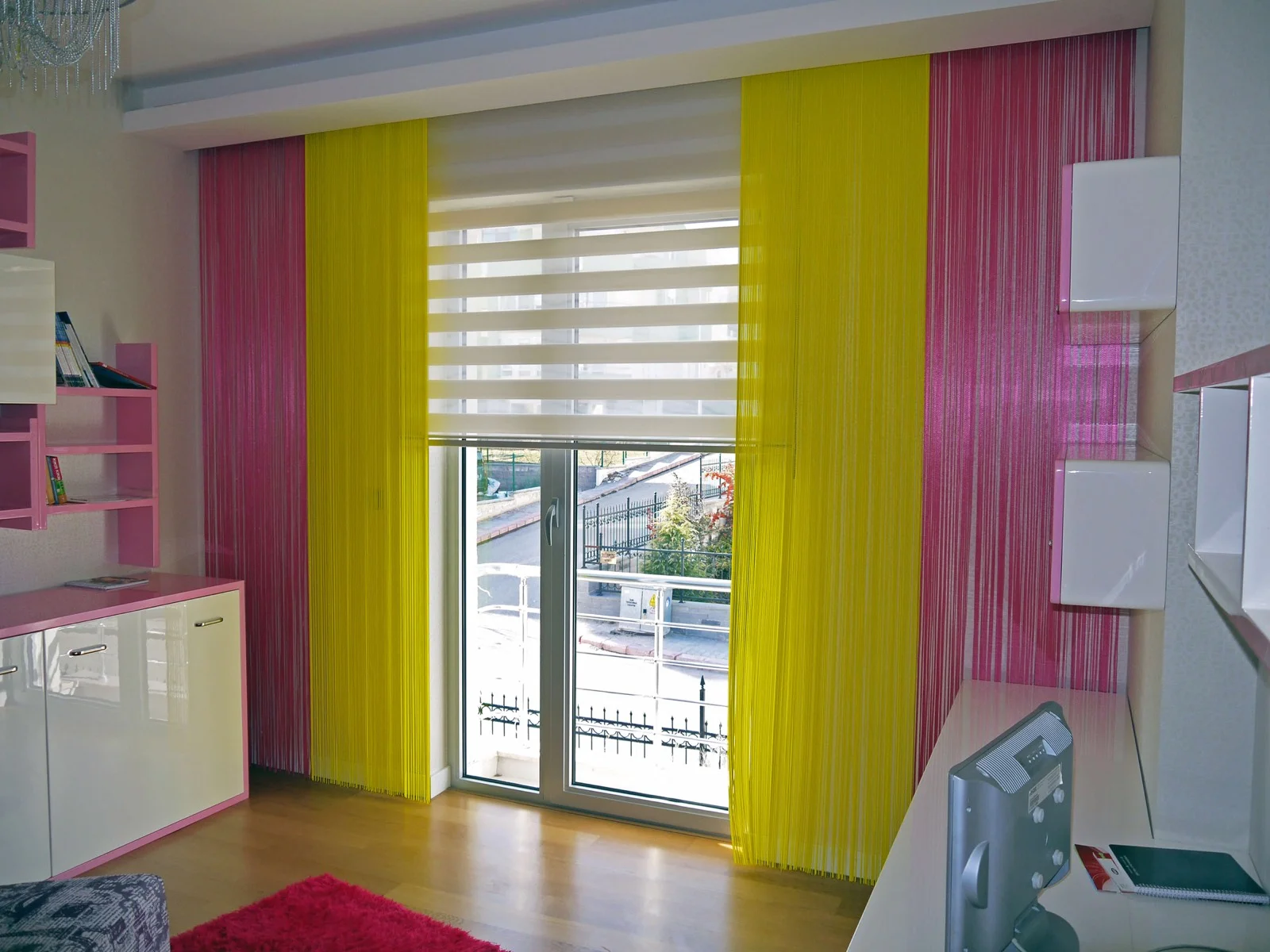 Yellow and pink string-curtain layers in a colourful room