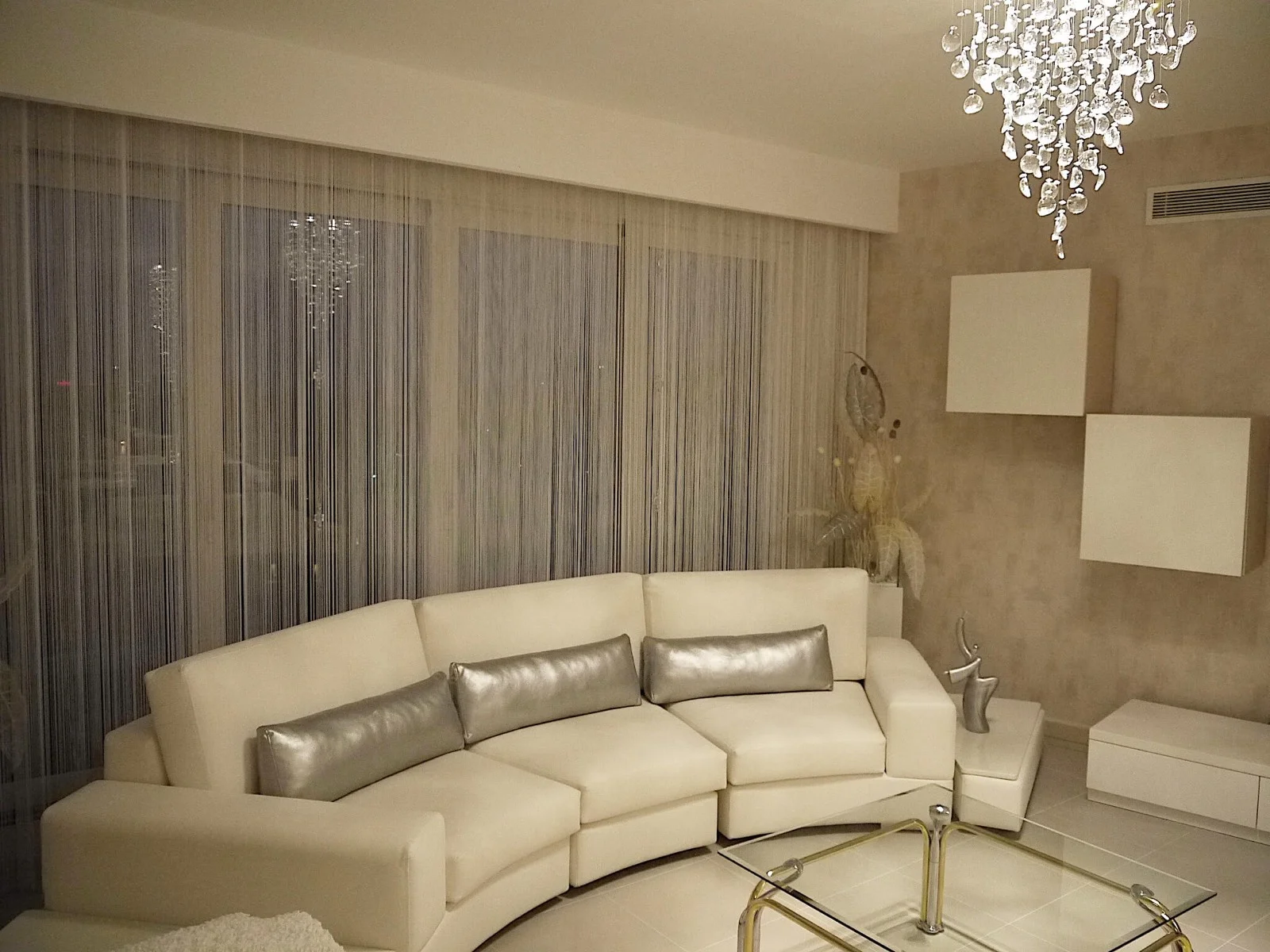 An overall view of string curtains in a corner living room