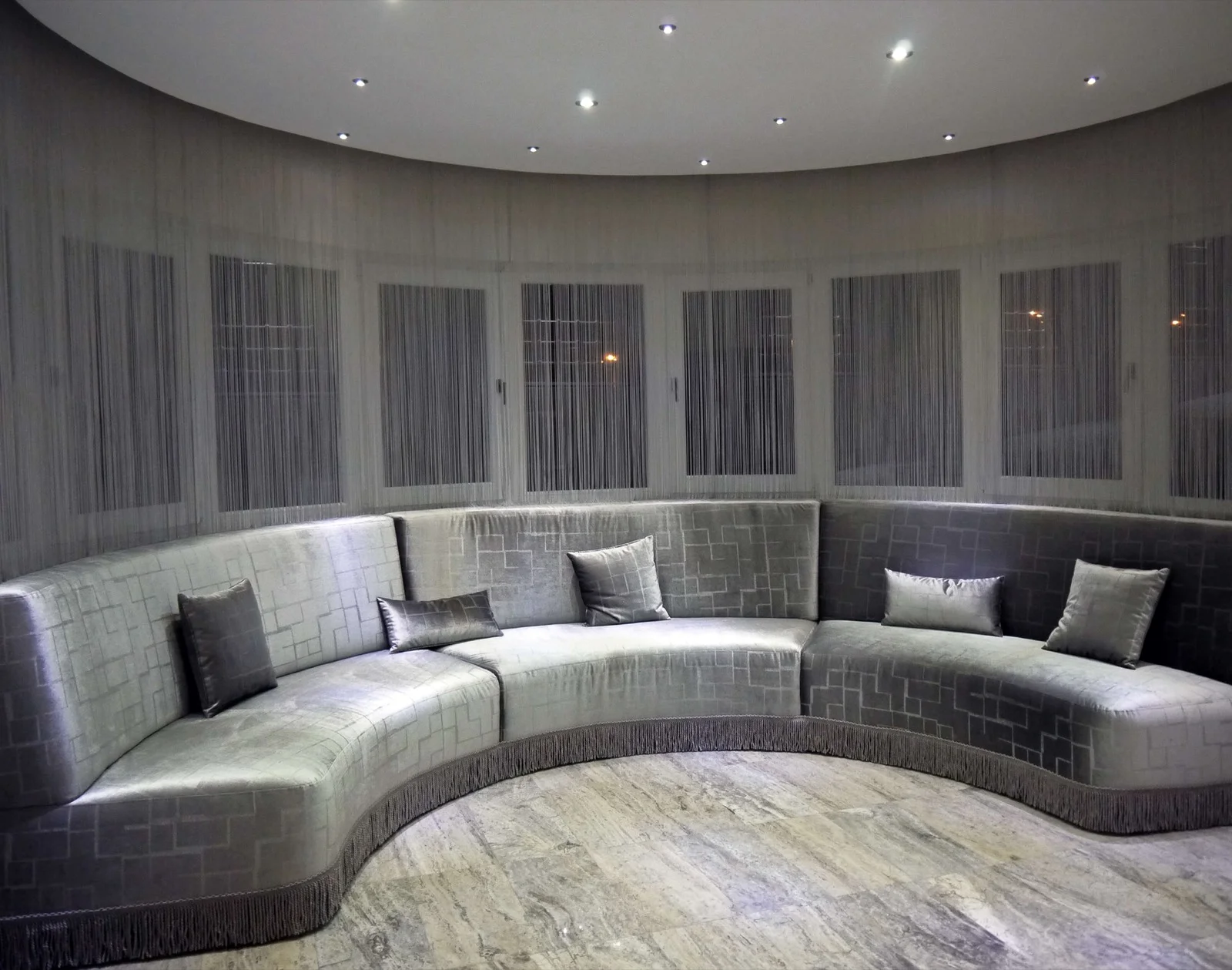 String curtains behind a curved seating area