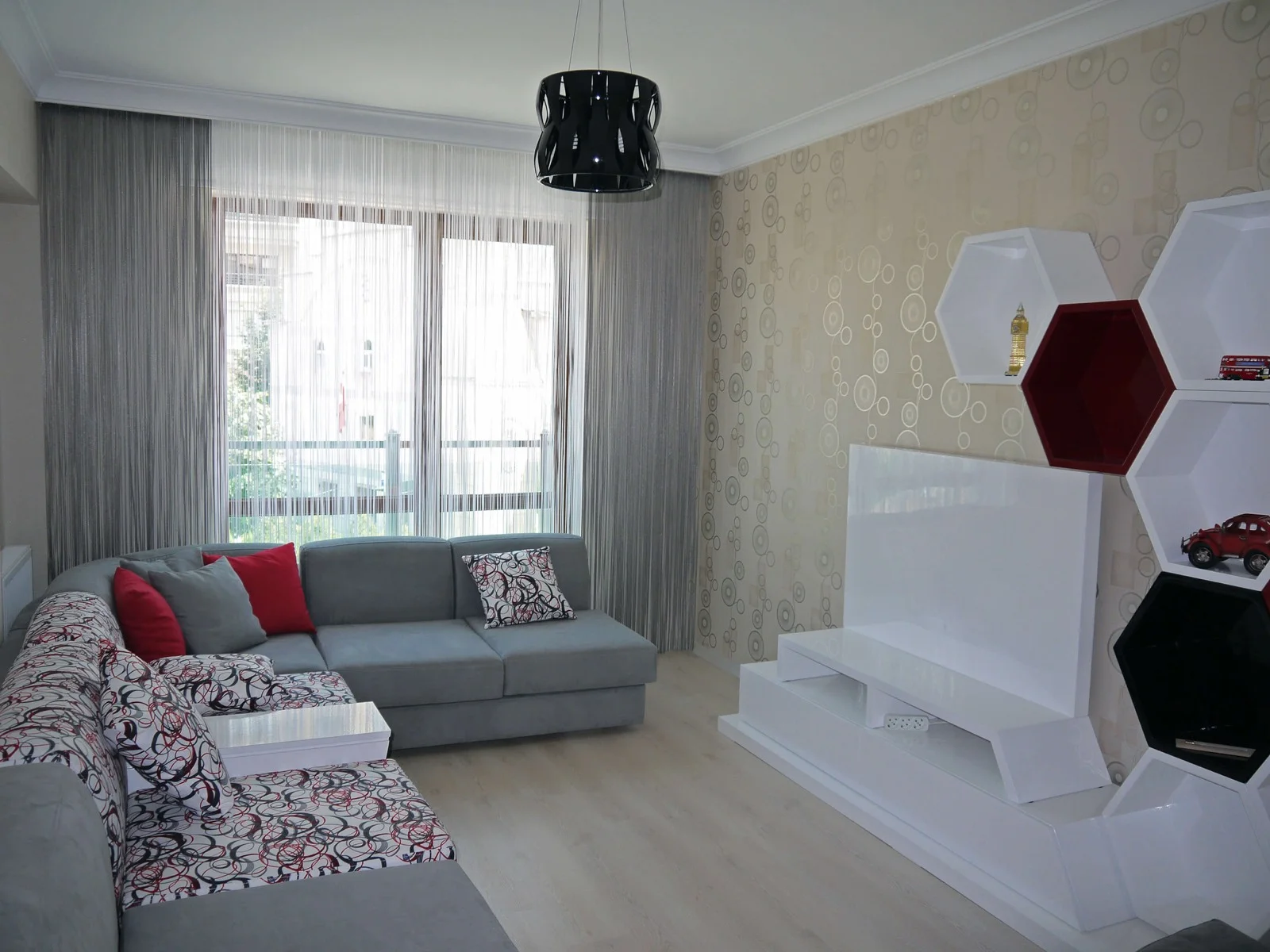 Light-coloured string curtains at a living-room window