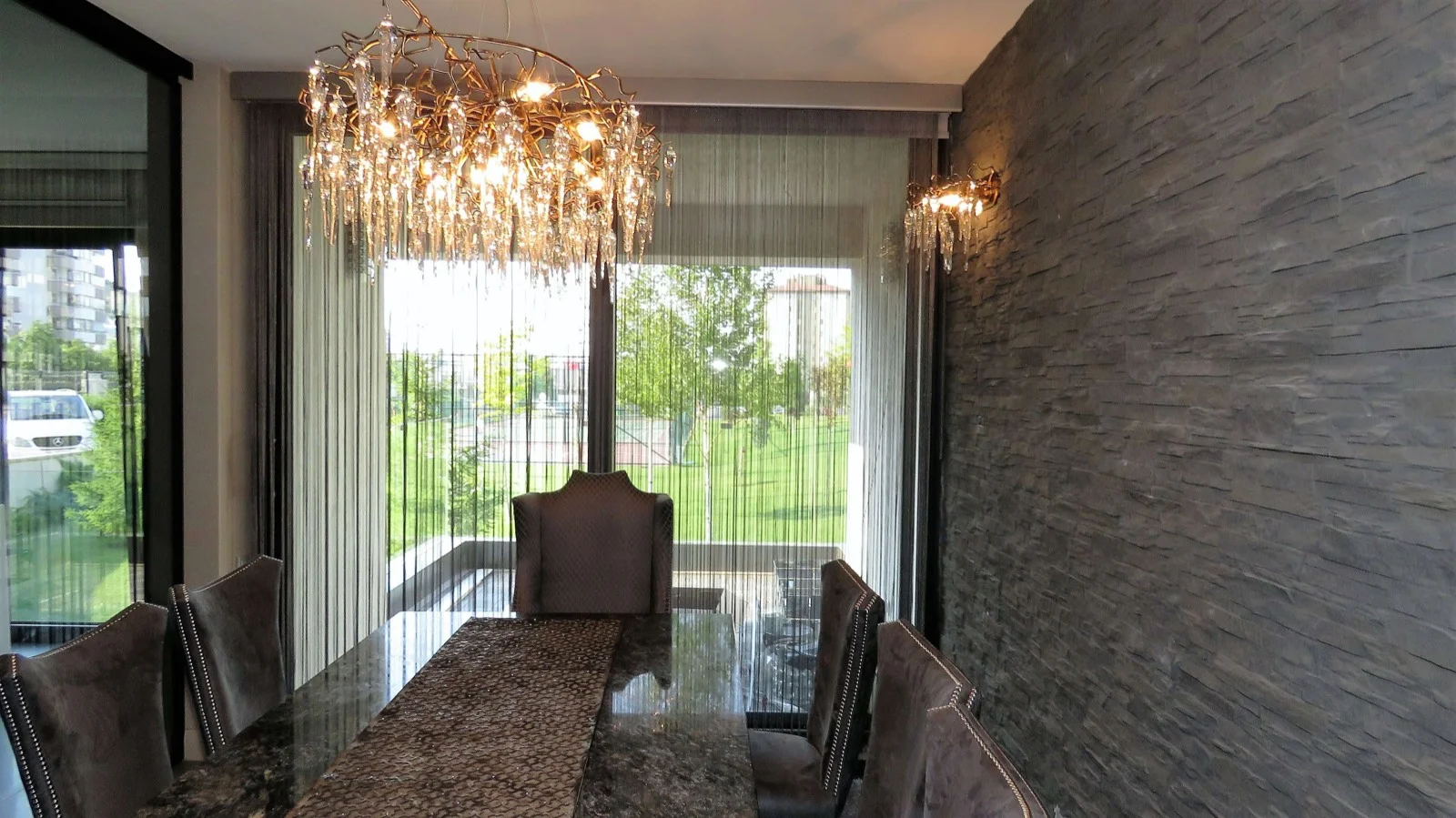 String curtains across glazing in a dining area
