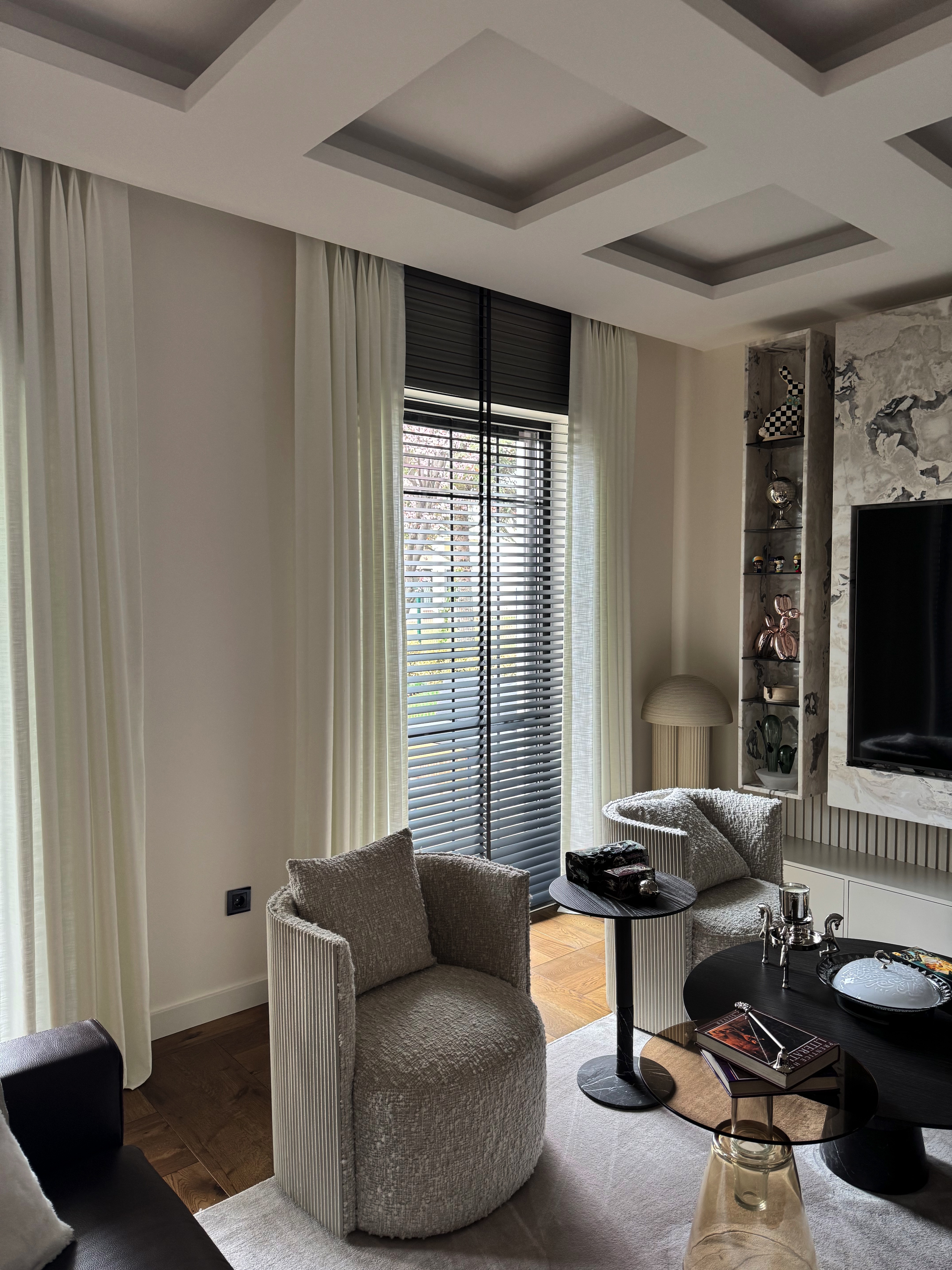 Somfy motorised wooden venetian blinds and linen curtains in the Angora Evleri living area