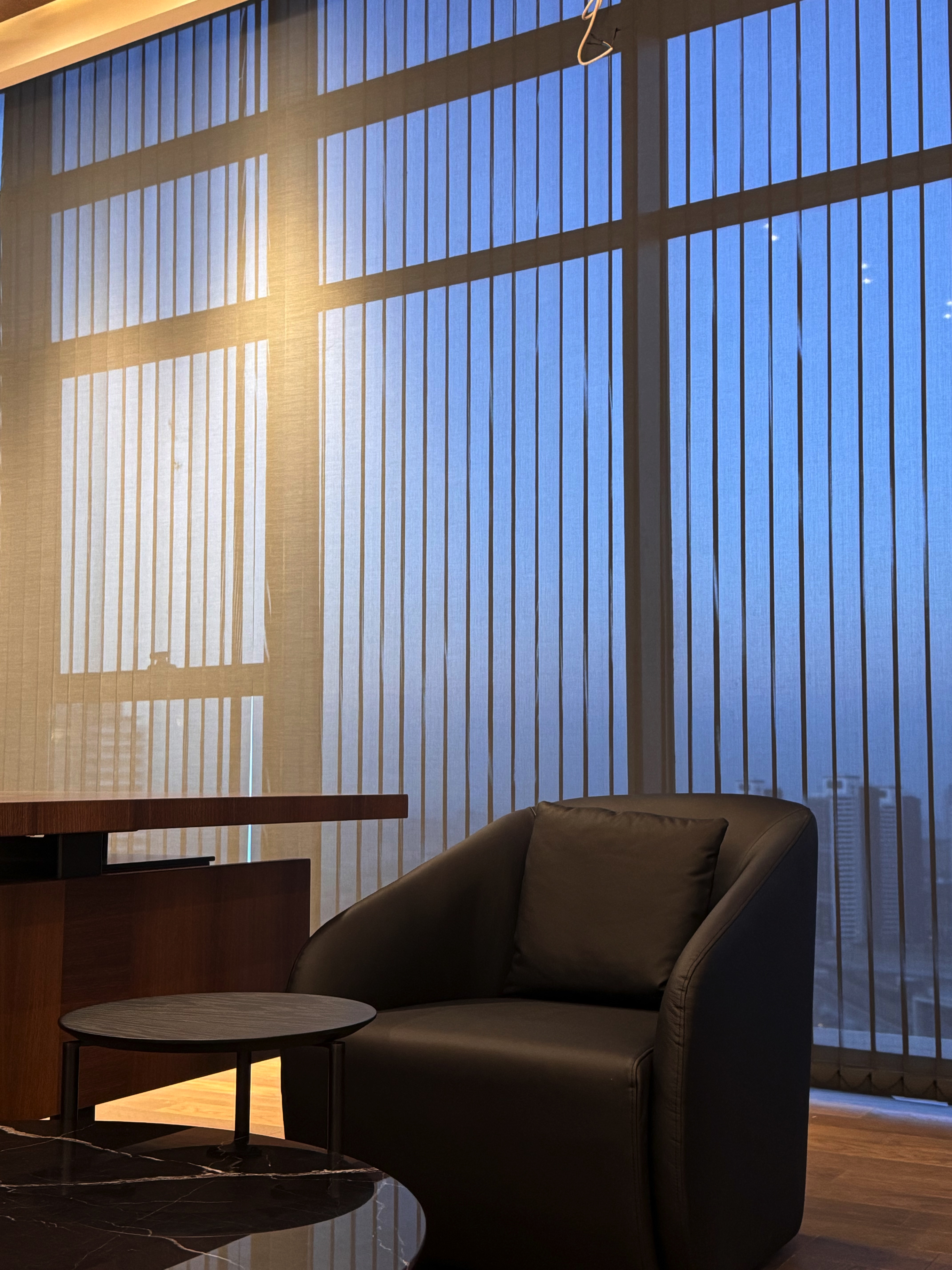 Light-coloured sunscreen vertical blinds filtering daylight in the Mira Ofis Beytepe work area